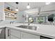 Modern kitchen island with white quartz countertop and stainless steel sink at 4901 38Th S Way # 304, St Petersburg, FL 33711