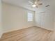 Spacious bedroom with wood-look floors and closet at 12125 Spartan Way # 201, Hudson, FL 34667
