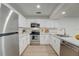 Modern kitchen featuring stainless steel appliances and white shaker cabinets at 12125 Spartan Way # 201, Hudson, FL 34667