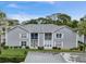 Aerial view of a gray building with gray roof and green landscaping at 12125 Spartan Way # 201, Hudson, FL 34667