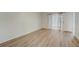 Bright bedroom with wood-look floors and sliding glass door at 12125 Spartan Way # 201, Hudson, FL 34667