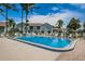 Sparkling community pool with surrounding lounge chairs and fencing at 12125 Spartan Way # 201, Hudson, FL 34667