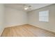 Charming bedroom with wood-look floors and window with blinds at 12125 Spartan Way # 201, Hudson, FL 34667