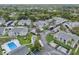 Complex aerial view showing buildings, pool, and parking at 12125 Spartan Way # 201, Hudson, FL 34667