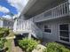 Gray building exterior with white trim, stairs, and balcony at 12125 Spartan Way # 201, Hudson, FL 34667