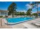 Inviting community pool with lounge chairs and umbrellas at 12125 Spartan Way # 201, Hudson, FL 34667