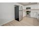 Modern kitchen with stainless steel appliances and white cabinets at 12125 Spartan Way # 201, Hudson, FL 34667