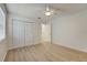 Well-lit bedroom with wood-look floors and double door closet at 12125 Spartan Way # 201, Hudson, FL 34667