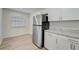 Modern kitchen with stainless steel appliances and white cabinets at 12125 Spartan Way # 201, Hudson, FL 34667