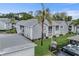 Gray building exterior with white trim, palm tree, and landscaping at 12125 Spartan Way # 201, Hudson, FL 34667