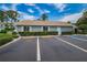Gray community building with ample parking and landscaping at 12125 Spartan Way # 201, Hudson, FL 34667