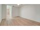 Spacious bedroom with wood-look floors and access to bathroom at 12125 Spartan Way # 201, Hudson, FL 34667