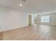 Bright living room with wood-look floors and ceiling fan at 12125 Spartan Way # 201, Hudson, FL 34667