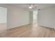 Spacious bedroom featuring wood-look floors and en-suite bathroom access at 12125 Spartan Way # 201, Hudson, FL 34667