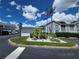 Community entrance with landscaping, flag, and stop sign at 12125 Spartan Way # 201, Hudson, FL 34667
