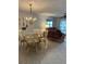 Cozy dining area with chandelier and adjacent living space at 5157 Silent Loop # 302, New Port Richey, FL 34652