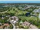 Beautiful aerial view of the community with golf course, lake, and tropical landscaping at 700 Starkey Rd # 333, Largo, FL 33771