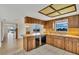 Kitchen with wood cabinets and breakfast bar at 10301 Gulf Blvd # 402, Treasure Island, FL 33706