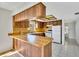 Kitchen with wood cabinets and tile floor at 10301 Gulf Blvd # 402, Treasure Island, FL 33706