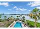 Community pool with water views and lounge chairs at 10301 Gulf Blvd # 402, Treasure Island, FL 33706