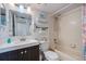 Cozy bathroom with a dark vanity, tub and shower combination, and beach-themed decor at 6219 Palma Del Mar S Blvd # 602, St Petersburg, FL 33715