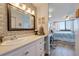 Tastefully designed bathroom with a large mirror, white vanity, and view into the bedroom at 6219 Palma Del Mar S Blvd # 602, St Petersburg, FL 33715