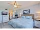 Inviting bedroom with a wicker headboard, ceiling fan, and soothing blue tones throughout the decor at 6219 Palma Del Mar S Blvd # 602, St Petersburg, FL 33715