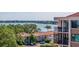 Scenic exterior view showing a building with balconies overlooking lush trees and a waterfront at 6219 Palma Del Mar S Blvd # 602, St Petersburg, FL 33715