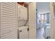 Convenient stacked washer and dryer unit in a closet, with a peek into the bedroom at 6219 Palma Del Mar S Blvd # 602, St Petersburg, FL 33715