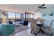 Open-concept living area with a dining set, comfortable seating, and bright natural light from large windows at 6219 Palma Del Mar S Blvd # 602, St Petersburg, FL 33715