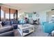Open-concept living space with a dining area, modern furniture, and water views at 6219 Palma Del Mar S Blvd # 602, St Petersburg, FL 33715