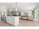 Open concept kitchen with island, stainless steel appliances, and view to living room at 47A Bayview S Ct, St Petersburg, FL 33711