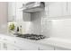 Modern kitchen features gas cooktop and white subway tile backsplash at 47A Bayview S Ct, St Petersburg, FL 33711