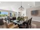 Spacious dining area with a large chandelier and access to living room and kitchen at 47A Bayview S Ct, St Petersburg, FL 33711