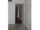 Bedroom with neutral walls and a view of the hallway with dark wood floors at 940 Virginia St # 107, Dunedin, FL 34698