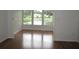 Sunroom with hardwood floors and a view of a pond and fountain at 940 Virginia St # 107, Dunedin, FL 34698