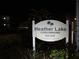 Night photo of Heather Lake Condominiums sign at 940 Virginia St # 107, Dunedin, FL 34698