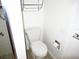 Simple bathroom with toilet and wall mounted shelving at 940 Virginia St # 107, Dunedin, FL 34698