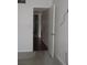 Clean hallway with wood flooring connecting bedrooms at 940 Virginia St # 107, Dunedin, FL 34698