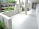 Exterior walkway with lush landscaping and parking area at 940 Virginia St # 107, Dunedin, FL 34698