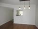 Light-filled dining area with hardwood floors and kitchen pass-through at 940 Virginia St # 107, Dunedin, FL 34698