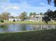 Scenic pond view with fountain and community buildings at 940 Virginia St # 107, Dunedin, FL 34698