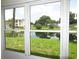 Window view of pond and lush landscape at 940 Virginia St # 107, Dunedin, FL 34698