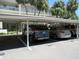 Covered parking area with several cars parked at 940 Virginia St # 107, Dunedin, FL 34698