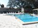 Community pool with multiple people swimming at 940 Virginia St # 107, Dunedin, FL 34698