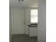Kitchen entry with granite countertop and white cabinets at 940 Virginia St # 107, Dunedin, FL 34698