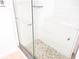 Walk-in shower with pebble floor and glass enclosure at 940 Virginia St # 107, Dunedin, FL 34698