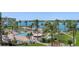 Community pool and spa with water view, lush landscaping, and palm trees at 6021 Bahia Del Mar Cir # 439, St Petersburg, FL 33715