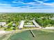 Aerial view of waterfront community with a pier and lush landscaping at 650 Pinellas Point S Dr # 128, St Petersburg, FL 33705
