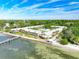 Aerial view of waterfront community, featuring a pool, pier, and lush landscaping at 650 Pinellas Point S Dr # 128, St Petersburg, FL 33705